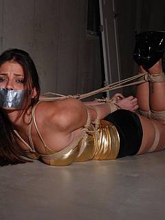 Abductor used a lot of rope tying leggy babe down until she became helplessly hogtied